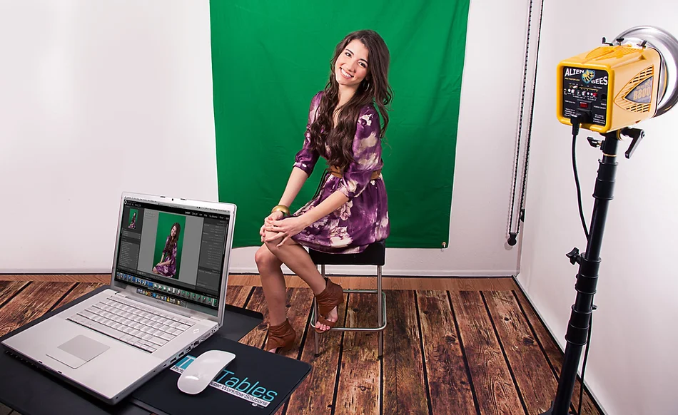 Woman posing in front of a green screen